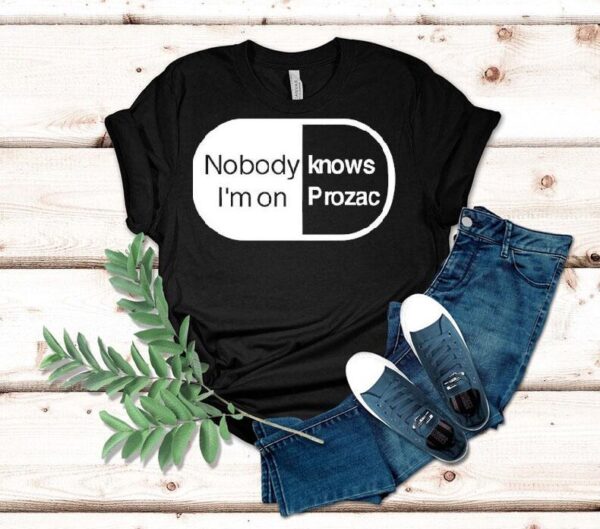 Robbie Williams Wearing Noboydy I’m On Knows Prozac Shirt