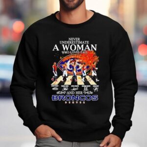 Never Underestimate A Woman Who Loves Fall And Her Denver Broncos Walking Across Signatures Sweatshirt