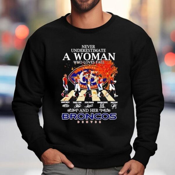 Never Underestimate A Woman Who Loves Fall And Her Denver Broncos Walking Across Signatures Shirt